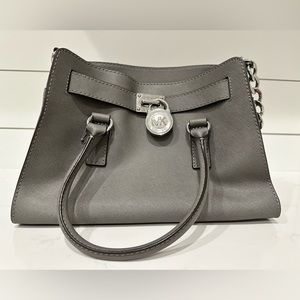 New Michael Kors Gray purse with chrome embellishments.
